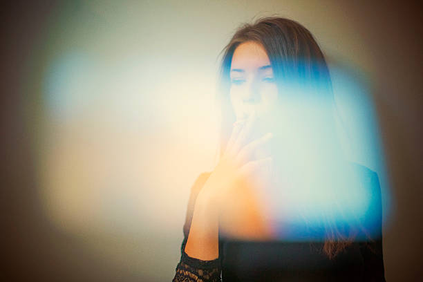 istock Young woman smoking 488535418
