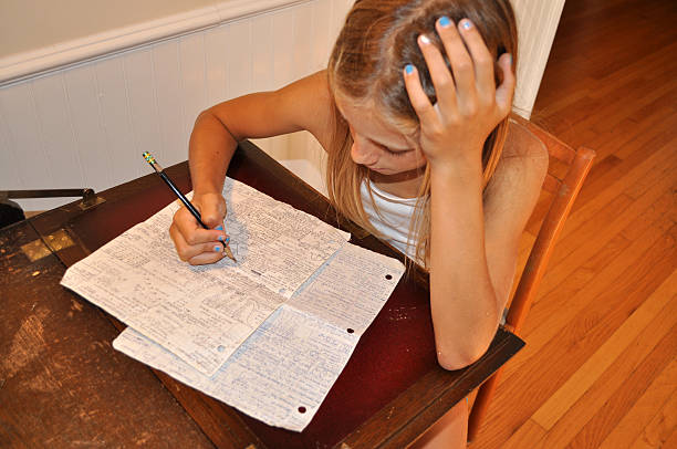 Young Girl Frustrated With Math Homework stock photo