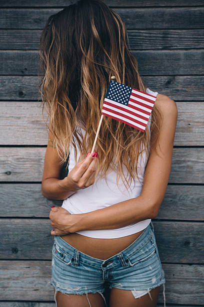 istock Young woman with American flag. 488535814