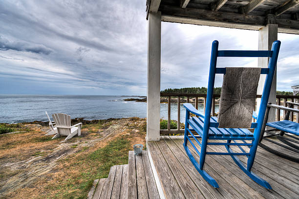 istock Rocking shairs on a porch with an ocean view 488536496