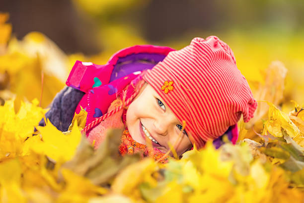 istock Little girl playing with autumn leaves 488536690