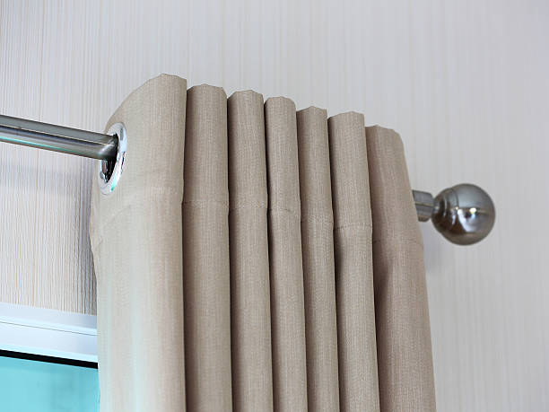 istock Cream colored curtains In steel rail 488544274