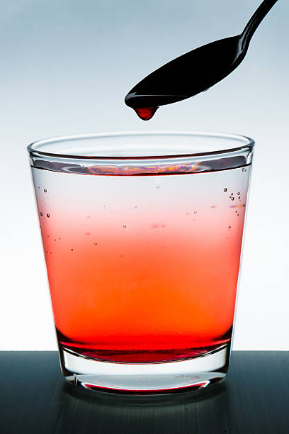 istock water drops from a spoon into a glass 488544512