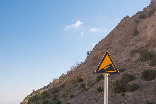 Downhill mountain in front of a downhill sign with a blue sky background