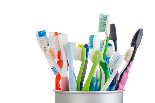 istock Group of old and used toothbrush in metal cup 488546148