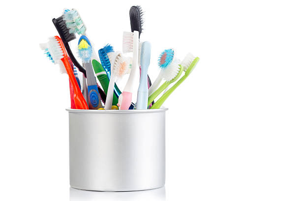 istock Group of old and used toothbrush in metal cup 488546152