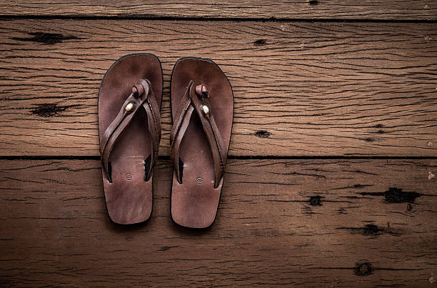 istock leather sandals on old wood background 488546950