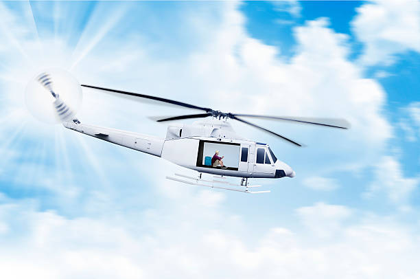 Asian tourist sitting inside helicopter while play with his cellphone