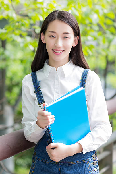 istock girl reading outdoors 488549818