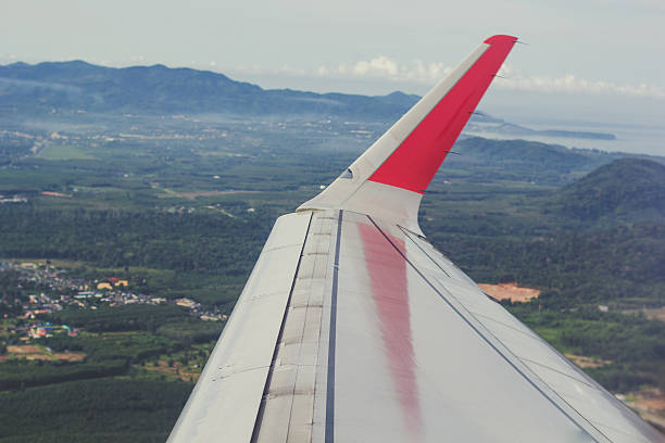 istock Wing of an airplane flying above the clouds 488550864