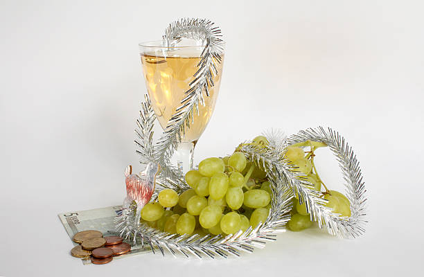 Wine and grapes Champagne wine and grapes - a New Year's still-life. euro bill in a christmas ornament stock pictures, royalty-free photos & images