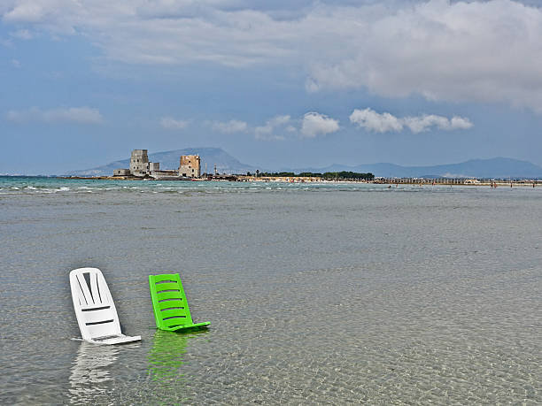 Mr Mozia. The Tin Mozia (Trapani - Sicily). Two deckchairs in the sea that for hundreds of meters is no deeper than 30 cm. In the background the Isola Lunga within walking distance. low tide stock pictures, royalty-free photos & images