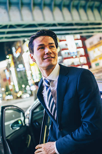 istock Businessman getting ou of a car 488555144