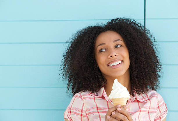 istock Smiling young woman enjoying ice cream 488556697