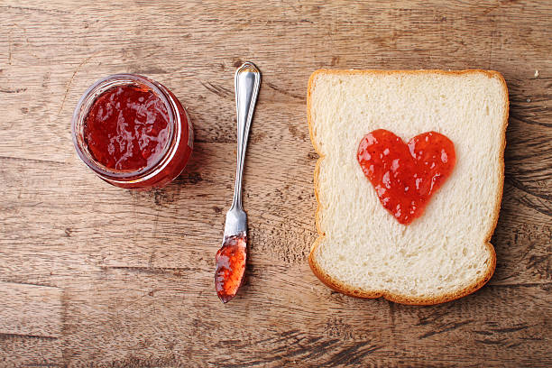 istock slice of bread with fruit jam heart shape 488556942