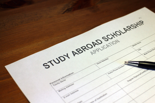 Someone filling out Study Abroad Scholarship Application Form.