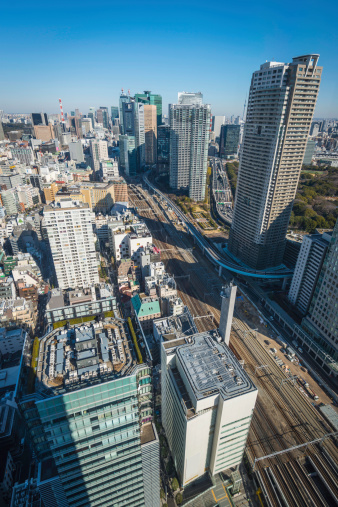 Aerial view over the crowded cityscape, streets, skyscrapers and railway tracks of downtown Tokyo, Japan. ProPhoto RGB profile for maximum color fidelity and gamut.