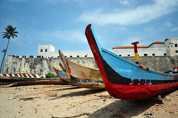 Ghana, Elmina castle Elmina, Ghana, West Africa: Elmina Castle, 15th century fortress built by the Portuguese - fishing boats prows and the beach - São Jorge da Mina castle, Feitoria da Mina, Portuguese Gold Coast - Unesco world heritage site - photo by M.Torres ghana photos stock pictures, royalty-free photos & images