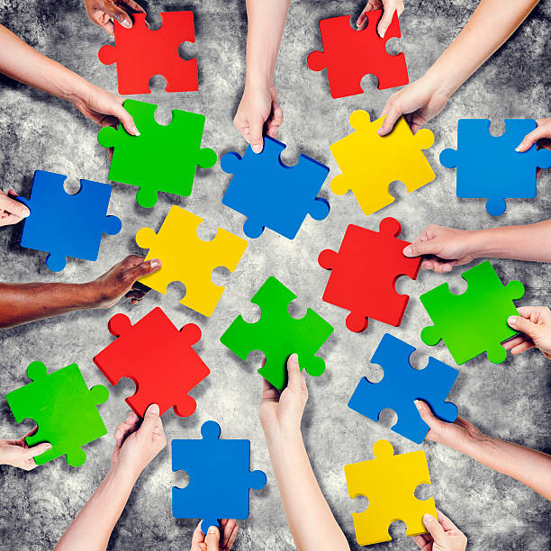 istock Group of Hands Holding Jigssaw Puzzle 488558388