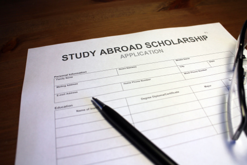 Someone filling out Study Abroad Scholarship Application Form.