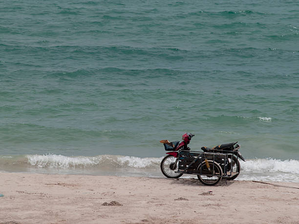 istock motorbike stands on the beach 488559000
