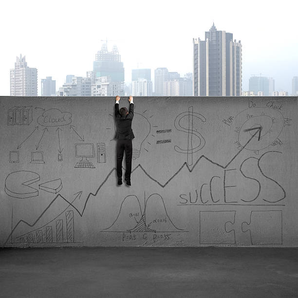 istock Man climbing over wall with business doodles 488559119