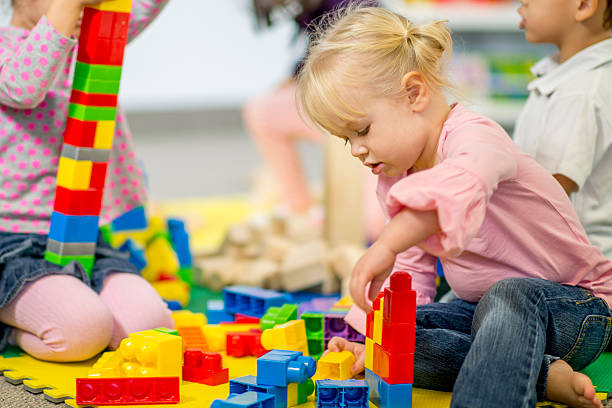 istock Little Girl Putting Together plastic blocks 488559254