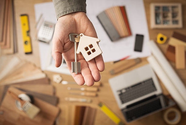 istock Real estate agent with house key 488560220