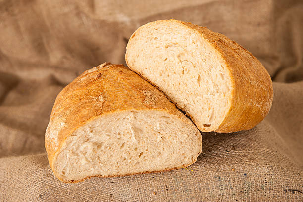 istock loaf of white bread on burlap background 488561091