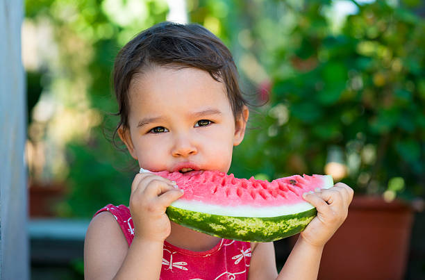istock Little girl eating watermelon 488561124