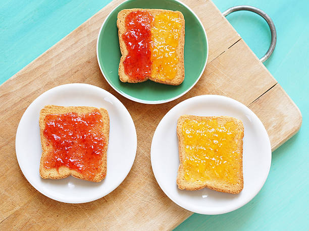 Toasts with jam Zwiebacks with apricot and strawberry jam for healthy breakfast zwieback toast stock pictures, royalty-free photos & images