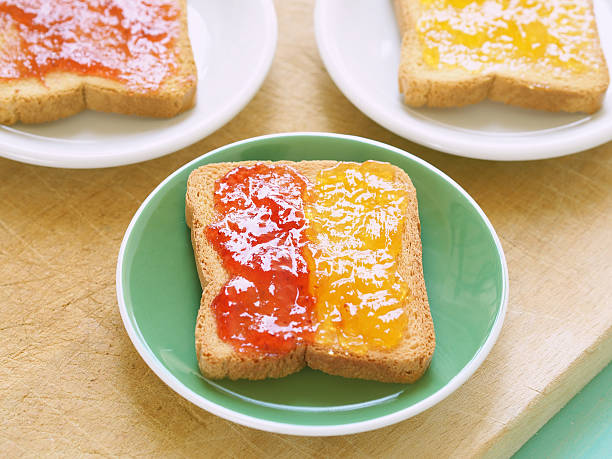 Toast with jam Zwiebacks with jam for continental breakfast zwieback toast stock pictures, royalty-free photos & images