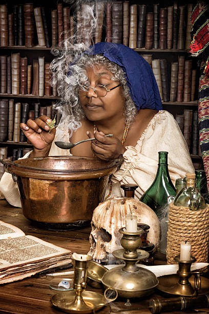 Herbs and smoke Vintage alchemist adding herbs to a smoking kettle. potion bottle retro revival old fashioned stock pictures, royalty-free photos & images