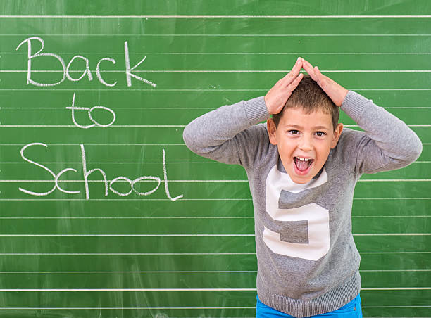 istock Student shows a board with the inscription: Back to School 488563500