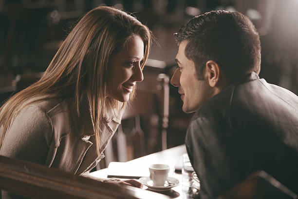 Romantic couple at the bar Romantic couple at the bar staring at each other's eyes mesmerised stock pictures, royalty-free photos & images