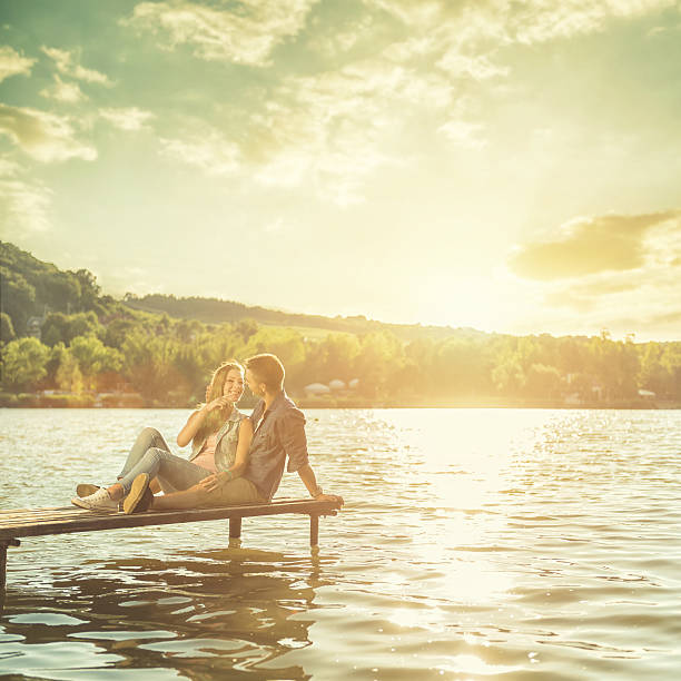 istock Couple in love sitting on the pier 488565114