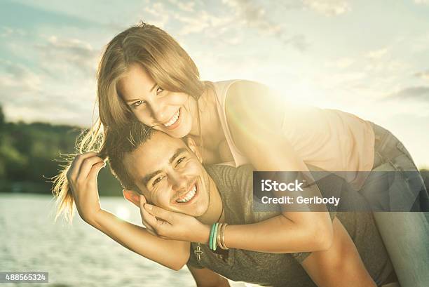 Couple In Love Embracing At The Lake Sun Flare Stock Photo - Download Image Now - Couple - Relationship, Kissing, Nautical Vessel