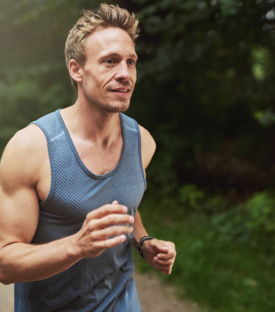 istock Handsome Muscular Man Jogging at the Park 488565410