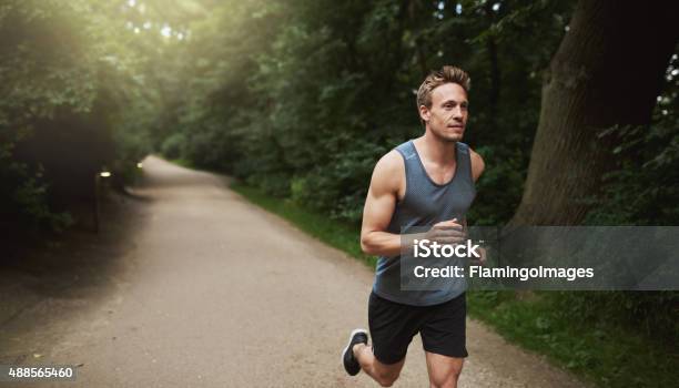 Athletic Man Doing Running Exercise At The Park Stock Photo - Download Image Now - Men, Running, Jogging