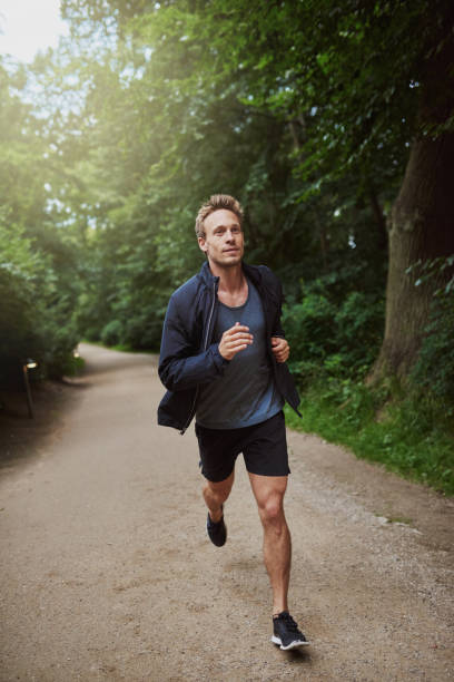 istock Man Jogging at the Park Early in the Morning 488565506