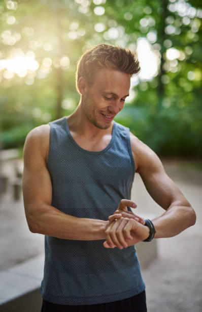 istock Muscular Man Checking his Watch After his Exercise 488565588