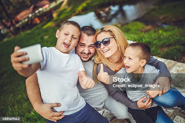 Family Taking Picture Stock Photo - Download Image Now - Adult, Boys, Carefree