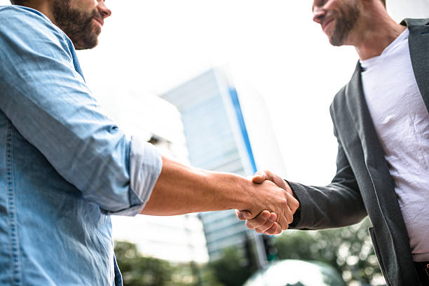 istock Business handshake on the financial district 488570232