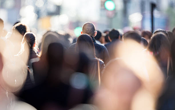 Candid business commuter crowd Heads of shoppers and commuters in a busy urban street scene. selective focus stock pictures, royalty-free photos & images