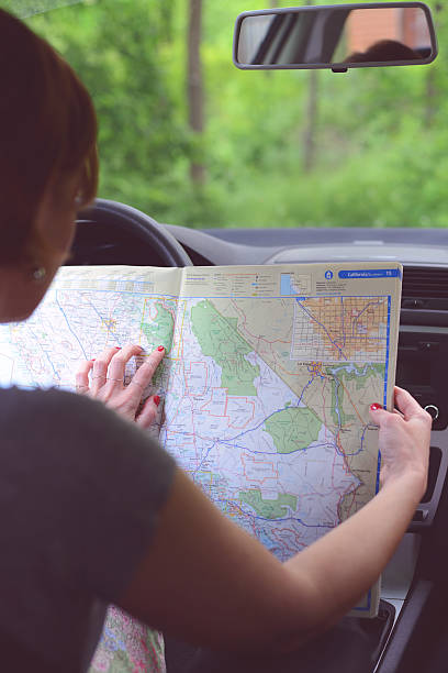 istock Young woman searching direction on the map 488571869