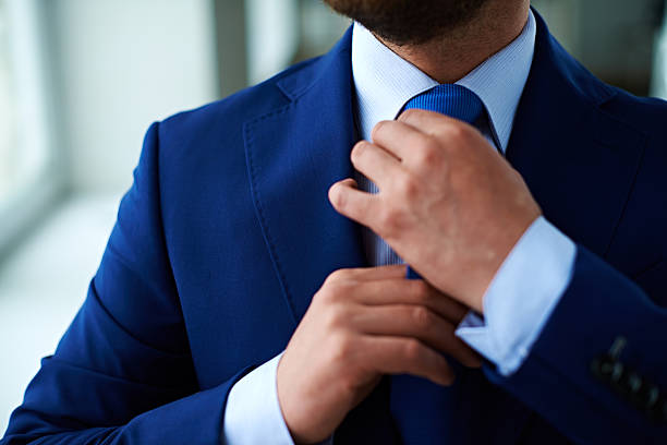 Business elegance Man in suit adjusting necktie man adjusting tie stock pictures, royalty-free photos & images