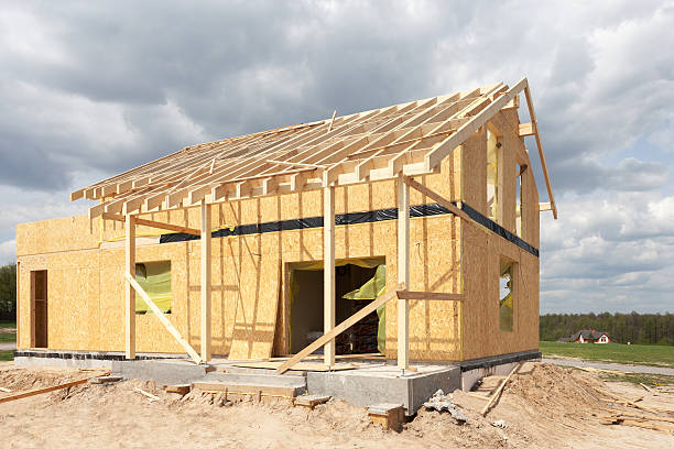 istock New residential frame house under construction against a blue sky 488574110