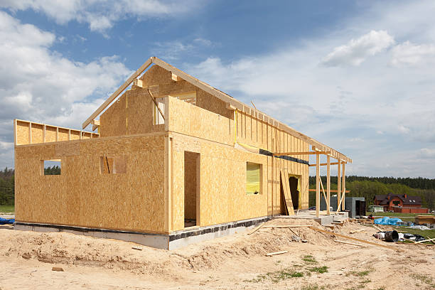 istock New residential frame house under construction against a blue sky 488574152