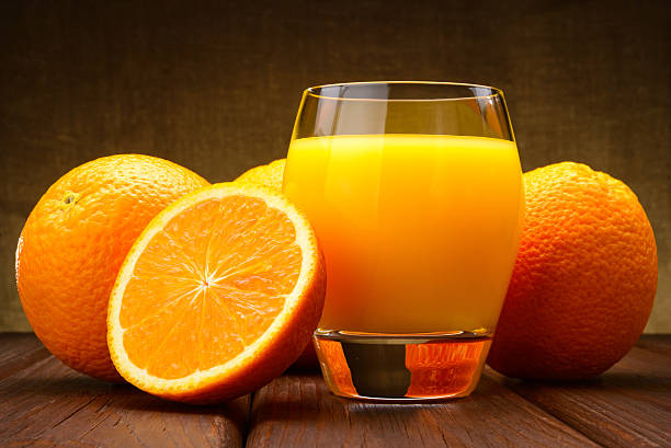 istock glass of Orange juice and oranges 488574221