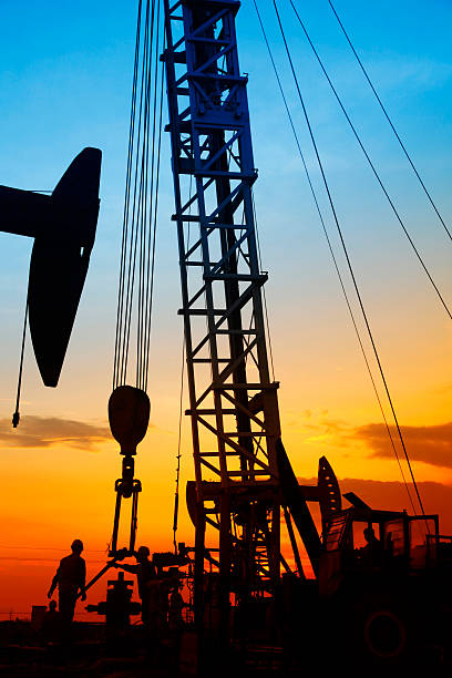 istock oil field, the oil workers are working 488574548